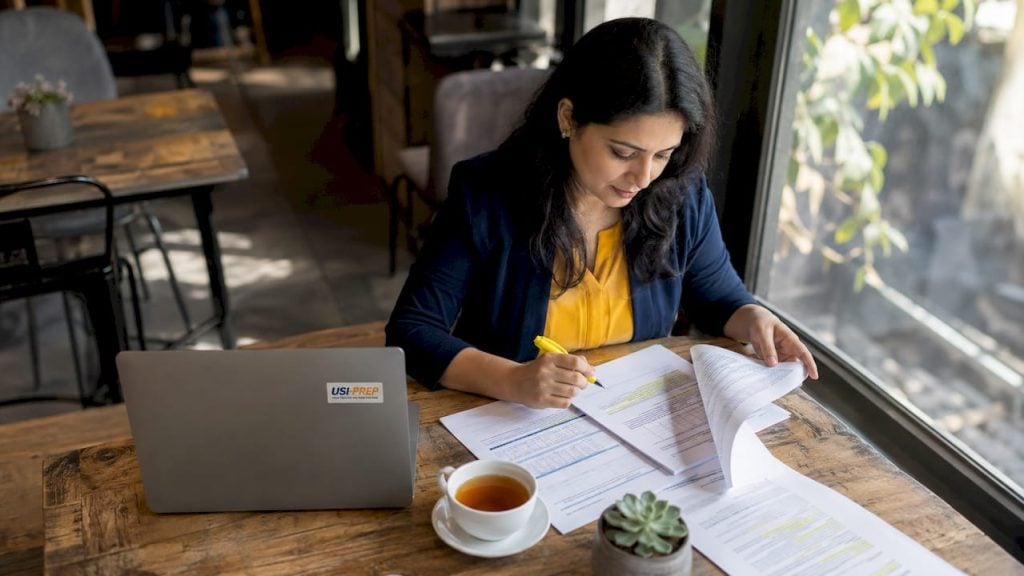Woman reviewing Walmart fulfillment documents at home office