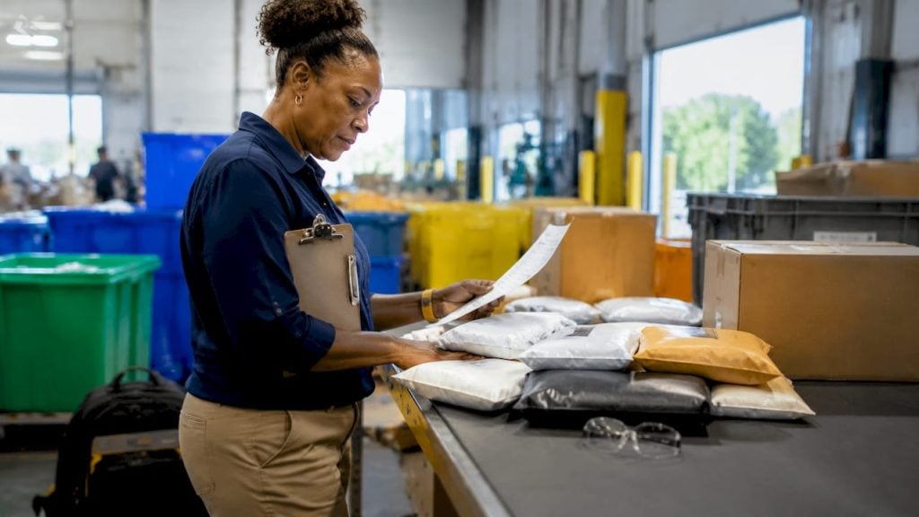 Woman managing returns paperwork in fulfillment office