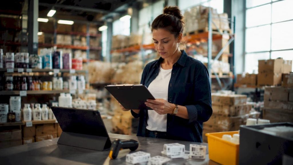 Warehouse manager reviewing inventory stock lists
