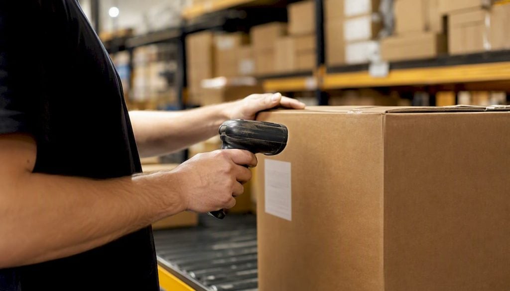 Worker scanning carton label at fulfillment center