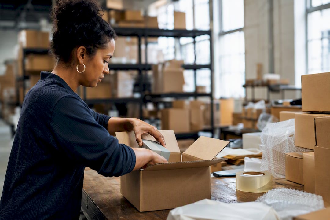Fulfiller packing multiple items into box