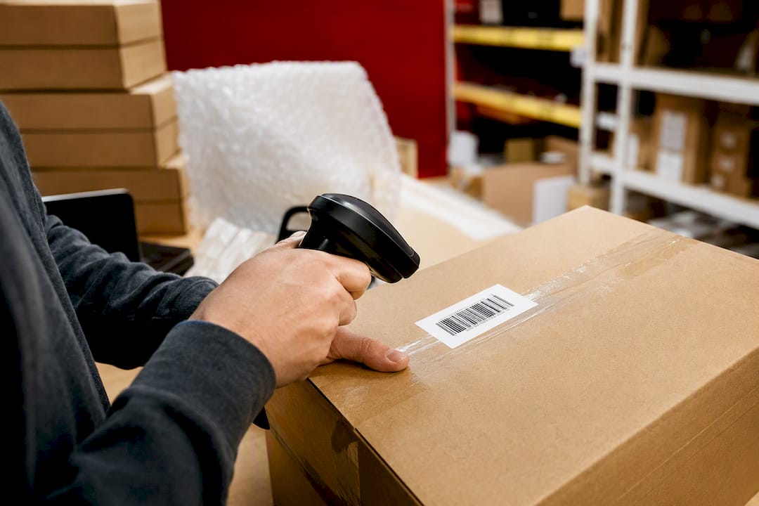 Hands scanning FNSKU label with barcode scanner